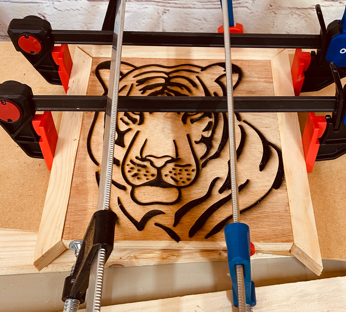 Tiger head laser engraved on plywood